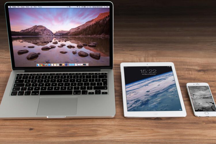 An image of a apple macbook, ipad and iphone.
