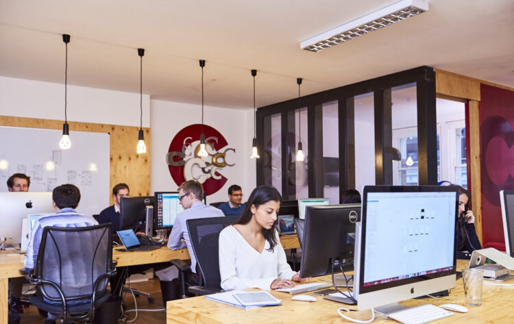 An image of developers in an office working on their computers.