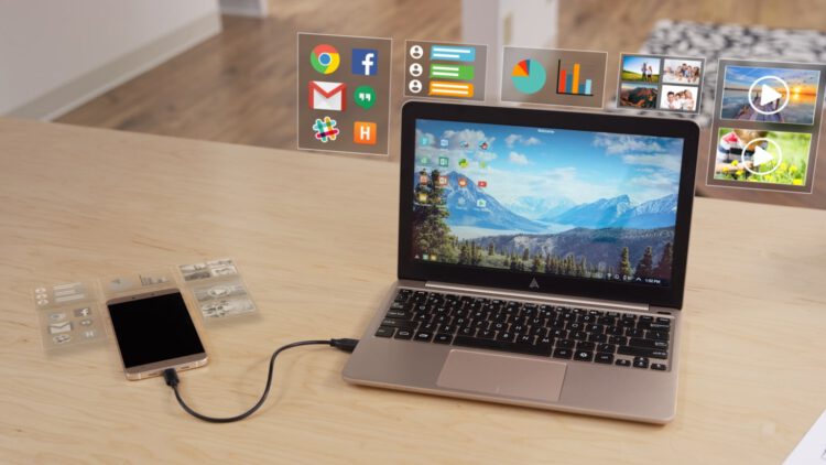 An image of a laptop and phone with AR applications floating around it.