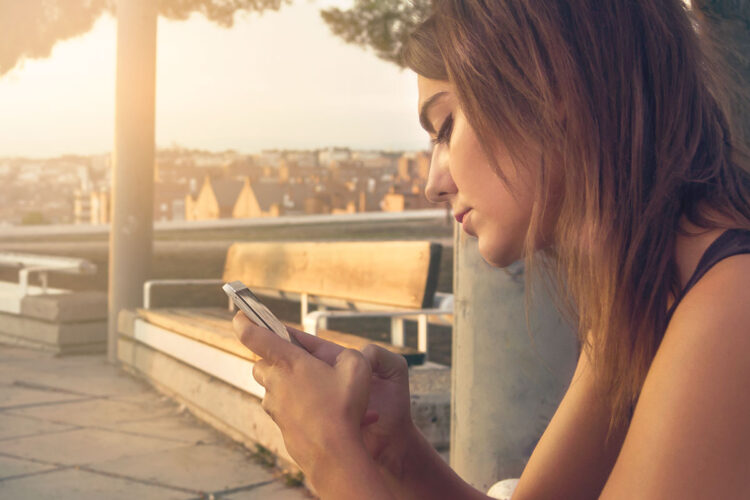 An image of a woman holding a phone.