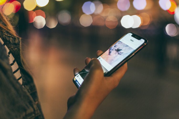 A female developer holding a phone.