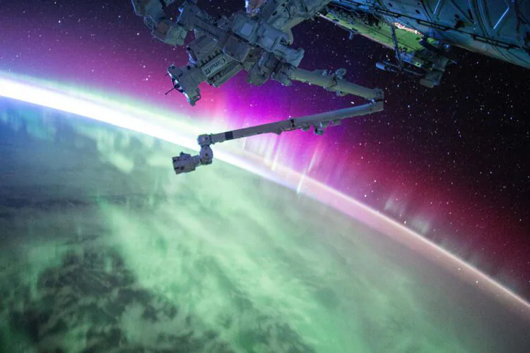 An image of earth and the bottom of the international space station.