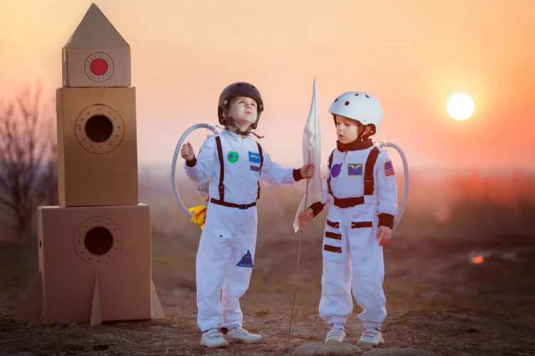 An image of two children in space suit costumes.