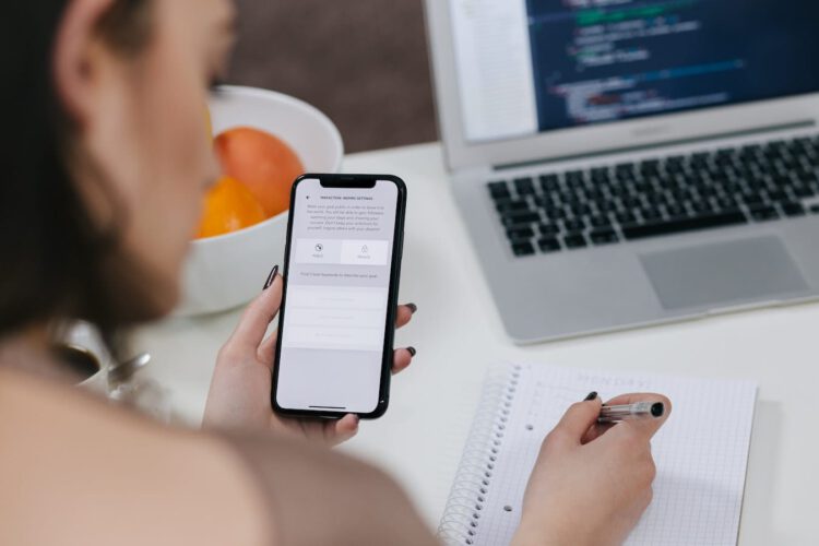 A female developer holding a phone.