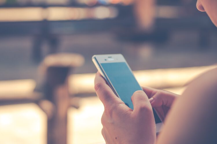 An image of a female using her phone.