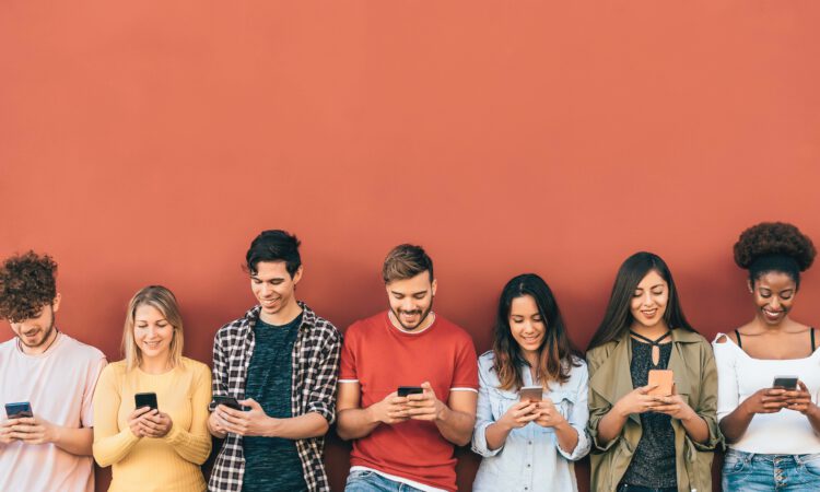 A group of young people looking at their mobile phones