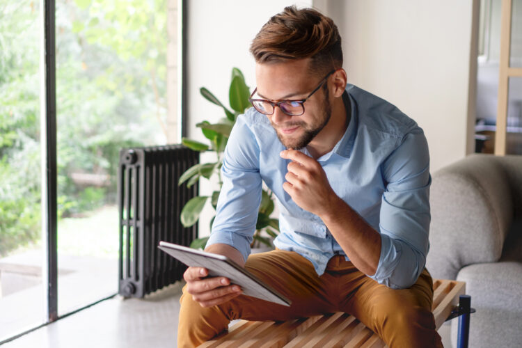 An image of a man looking at his tablet.