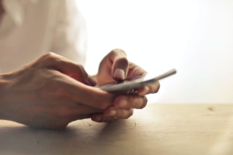 An image of a man using his phone.