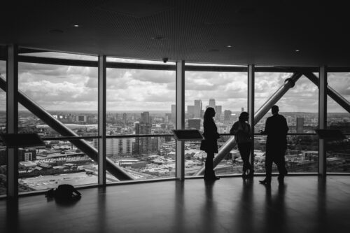 An image of 3 business people looking over at the city.