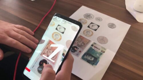 A phone is taking an image of money.