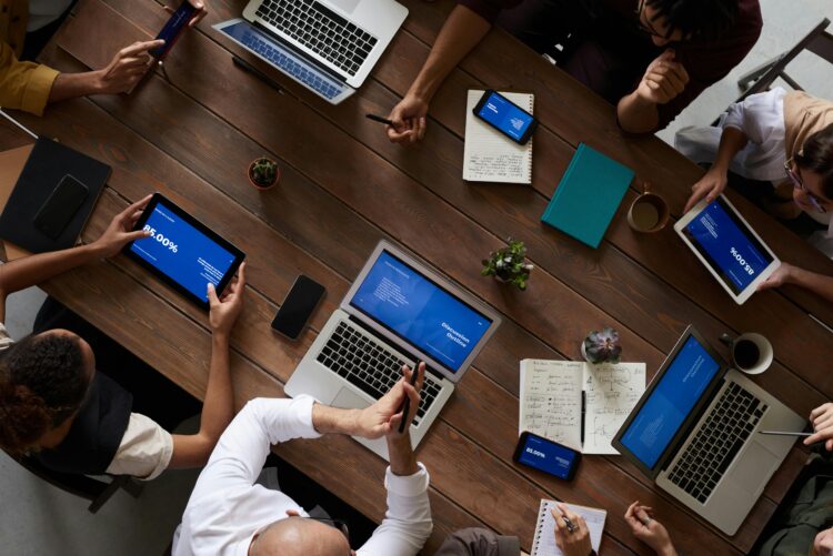 An image of a team around table working on the same project.